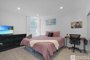 San Diego condo for rent - A bedroom with a bed, desk, and chair.