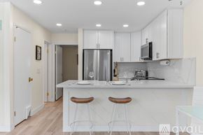 San Diego condo for rent - A kitchen with white cabinets and a white countertop.