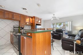 St. Pete Beach apartment for rent - A kitchen with wooden cabinets and a green countertop.