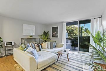 San Diego condo for rent - A living room with a white couch and a rug.