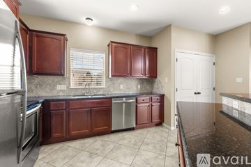 College Station apartment for rent - A kitchen with brown cabinets and a marble countertop.
