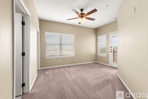 College Station apartment for rent - A room with a ceiling fan and carpeted floor.