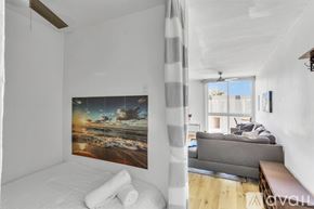 San Diego condo for rent - A bedroom with a large bed and a painting on the wall.