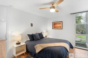 San Diego condo for rent - A bedroom with a bed, nightstand, and a ceiling fan.