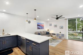 San Diego condo for rent - A modern kitchen with dark blue cabinets and a white countertop.