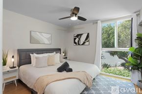San Diego townhouse for rent - A bedroom with a large bed and a ceiling fan.