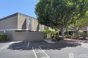 San Diego townhouse for rent - A modern building with a parking lot in front.