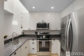 San Diego townhouse for rent - A modern kitchen with a stainless steel refrigerator and a microwave above the stove.