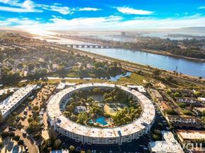 San Diego townhouse for rent - A large circular building with a pool in the middle is surrounded by a road and greenery.