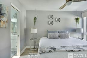 San Diego townhouse for rent - A bedroom with a large bed and a ceiling fan.