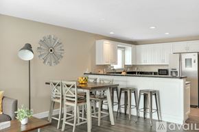 San Diego condo for rent - A kitchen with a bar stool and a table with chairs.