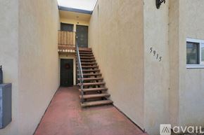San Diego condo for rent - A staircase in a building with the number 5915 on the wall.