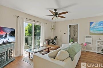 San Diego condo for rent - A living room with a white couch and a ceiling fan.
