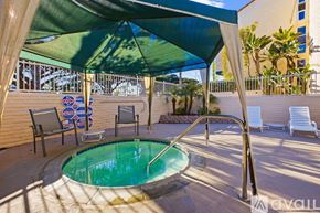 San Diego condo for rent - A kitchen with wooden cabinets and granite countertops.