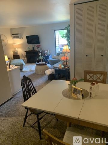 Oregon apartment for rent - A living room with a white dining table and chairs.