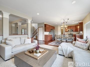 Albertville house for rent - A living room with a white couch and a coffee table in the center.