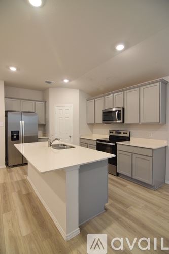 Temple house for rent - A kitchen with a white countertop and wooden flooring.