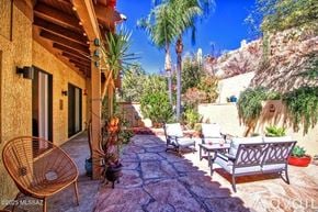 Oro Valley townhouse for rent - A patio with a chair and a table is surrounded by plants.