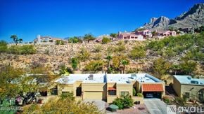 Oro Valley townhouse for rent - A house with a red roof is surrounded by other houses and vegetation.