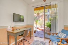 Oro Valley townhouse for rent - A bedroom with a bed, dresser, and ceiling fan.