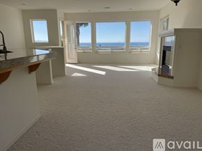 Pismo Beach house for rent - A spacious living room with a view of the ocean through large windows.
