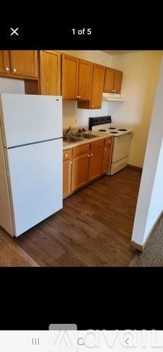 Waterloo house for rent - A kitchen with wooden cabinets and a white refrigerator.