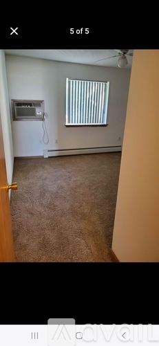 Waterloo house for rent - A room with a window covered by blinds and a wall-mounted TV.