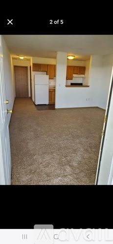 Waterloo house for rent - A room with a carpeted floor and a white refrigerator.