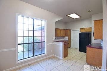Killeen apartment for rent - A kitchen with a black refrigerator, a microwave, and a stove top oven.