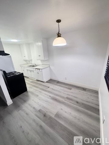 Azusa apartment for rent - A kitchen area with a refrigerator, stove, and cabinets.