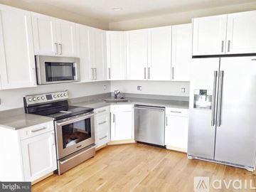 Washington apartment for rent - A kitchen with white cabinets and stainless steel appliances.