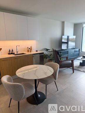 Miami apartment for rent - A modern kitchen with a table and chairs.