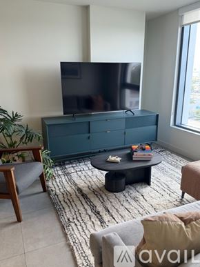 Miami apartment for rent - A living room with a flat screen TV on a cabinet.