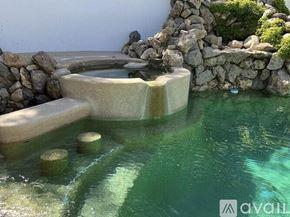 Westlake Village house for rent - A small pool with a waterfall and rocks.