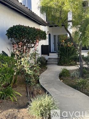 Oak Park condo for rent - A white house with a garden in front.