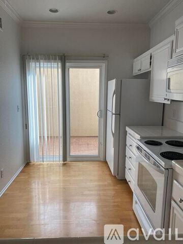 Oak Park condo for rent - A kitchen with white cabinets and a stove top oven.