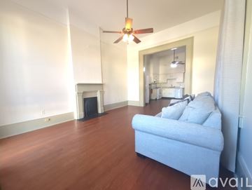 New Orleans apartment for rent - A living room with a blue couch and a fireplace.