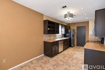 Killeen house for rent - A kitchen with brown cabinets and a tiled floor.