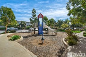Encinitas house for rent - A playground with a blue slide and a red and white sign.