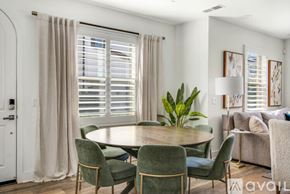 Encinitas house for rent - A dining room with a round table surrounded by chairs.