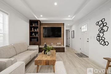 Andover house for rent - A living room with a wooden coffee table and a grey sofa.