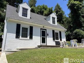 Charlottesville house for rent - A white house with a black door and windows.