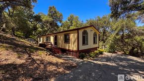 Topanga apartment for rent - A wooden deck with a red railing and a green roof.