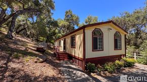 Topanga apartment for rent - A small house is surrounded by trees and a wooden fence.
