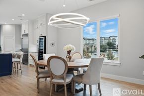 Flower Mound townhouse for rent - A modern dining room with a table set for four.