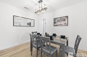 San Diego house for rent - A dining room with a table set for two and a chandelier hanging from the ceiling.