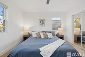 San Diego house for rent - A bedroom with a large bed and a mirror on the wall.