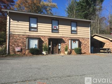 Boone apartment for rent - A building with a brown facade and a blue door.