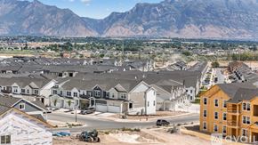 Lehi apartment for rent - A housing development with mountains in the background.