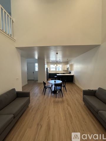 Lehi apartment for rent - A living room with a grey couch and a black table.